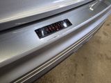 a sticker on the bumper of a silver car