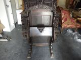a wooden chair that is sitting in the middle of a room