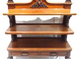 a wooden shelf with three shelves on top of it