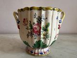 a vase with flowers on it sitting on a table