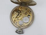 an old pocket watch with a chain hanging from it ' s side