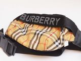 a yellow and black bag with a black strap on it