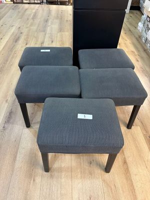 four stools and a small table in a store