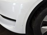 a close up of a white car with black rims