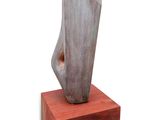 statue of a woman ' s foot on a wooden base