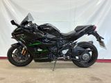 a picture of a black motorcycle parked in a garage