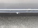 a close up of a car ' s bumper with a hole in it