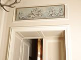 a deer head mounted on the wall above a doorway