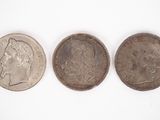 three british coins, one of which is a sovereign and one of which is a sovereign