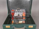 a green suitcase with a bunch of items inside of it