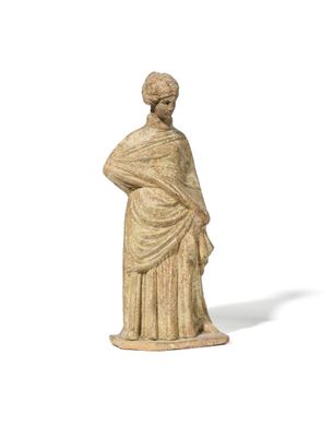 an old statue of a woman standing with her hands on her hips