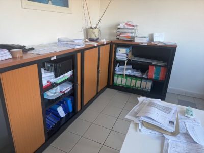 a desk with a bunch of papers on it in a room