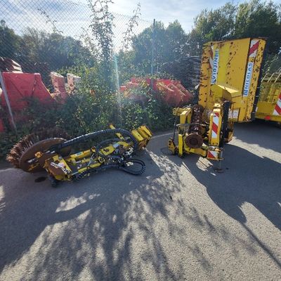 two machines that are sitting on the side of the road