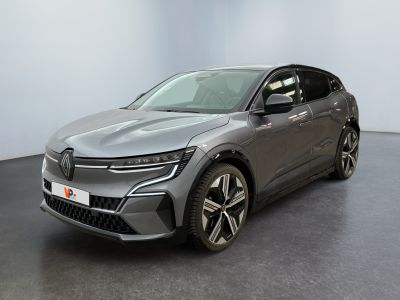 the grey car is parked in a large room with a black floor