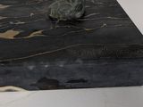 a statue of a man sitting on top of a box