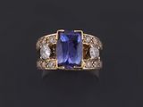 a tan and white gold ring set with a tan sapphire and white diamonds