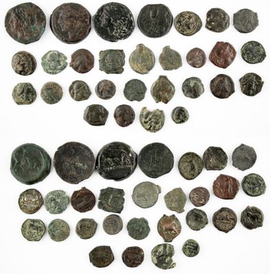 a group of ancient roman coins on a white surface