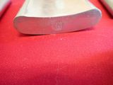 a metal object on a red surface with a keyboard in the background