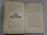 an open book with a drawing of a cake on it