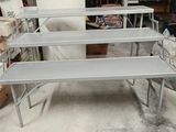 four metal shelves that are stacked on top of each other