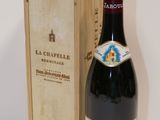 a bottle of wine sitting next to a wooden box