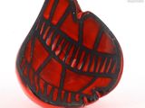 an image of a red and black ring on a white surface