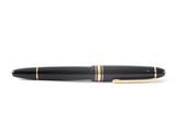 a close up of a pen on a white surface with a white background