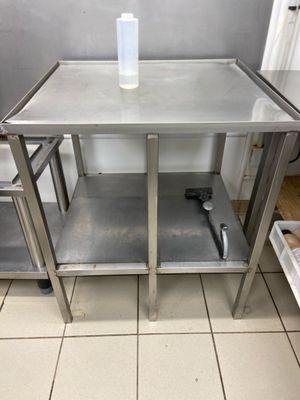 a stainless steel table with a bottle on top of it