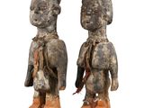 pair of carved wooden figures of a man and a woman