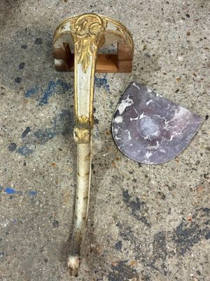 a knife that is laying on the ground next to a rock