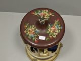 a small brown box with flowers on it on a table