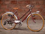 a bike that is parked in front of a brick wall