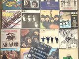 a lot of beatles album covers on the floor