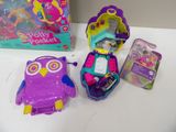 a purple owl toy and a purple owl bag on a white table
