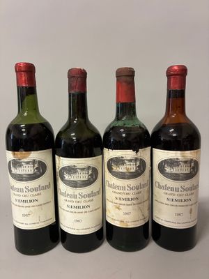 four bottles of wine are lined up on a table