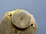 a brass plate with writing on it on a blue surface