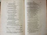 an open book with a poem on it sitting on a table