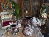three vases sitting on a glass table in a living room