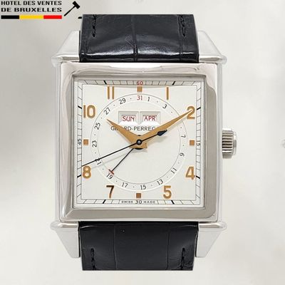 a silver watch with a black strap on it