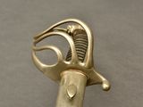 a metal object that looks like a hand holding a knife