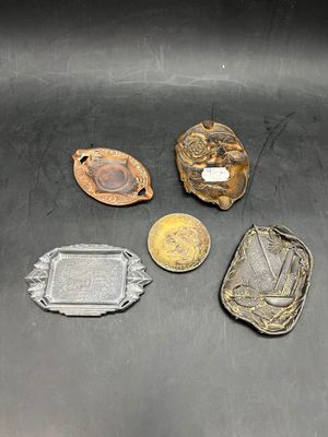 several different metal objects are sitting on a black surface