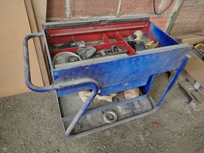 a blue cart with tools in it sitting on the ground