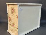 white wooden box with a floral design on the front
