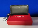 a black and green wallet sitting on top of a red box
