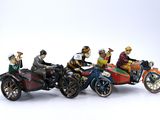 five figurines of people riding on a motorcycle and a car