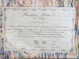 a certificate on a piece of cloth on a table