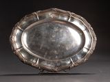 a silver plate that is sitting on a stand