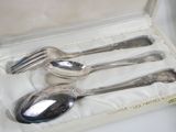 four silver spoons and two silver spoons in a box