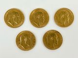 four gold sovereigns, one of which has a crown on it