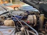 a close up of a car ' s engine with its hood open